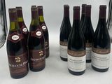several bottles of wine are lined up on a table