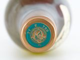 a close up of a bottle of wine on a white surface