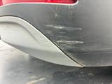 a close up of a car ' s rear bumper with scratches