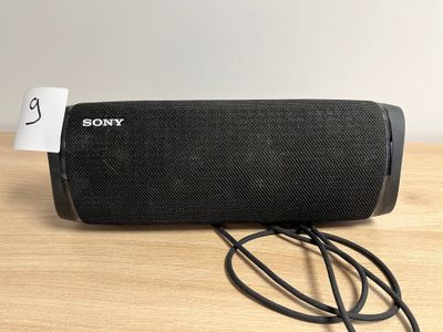 L'enceinte portable Sony est branchée sur un chargeur