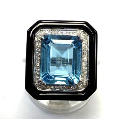 an image of a ring with a blue topaz stone surrounded by white and black diamonds
