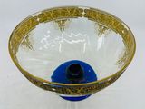 a blue and gold bowl on a white table