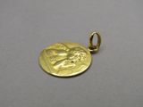 a close up of a gold coin with a woman on it