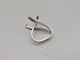 a close up of a silver ring on a white surface