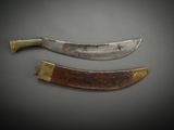 two knives are sitting side by side on a gray surface