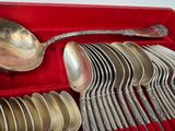 a lot of silver spoons and spoons in a red box