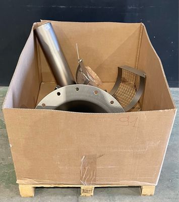 a cardboard box with a metal object inside of it