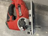 a picture of a corded jig saw sitting on the ground