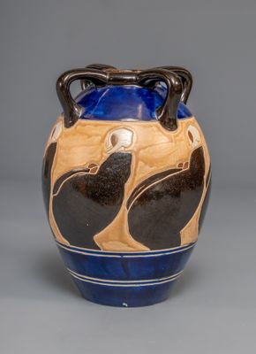a blue and brown vase with black birds on it