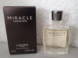 an image of a bottle of perfume next to a box