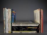 many books stacked on top of each other on a table
