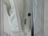 a white dress on a mannequin stand in front of a mirror