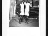 black and white photograph of two women in white dresses standing next to each other