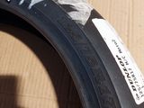 a tire with a sticker on it sitting on a cardboard box