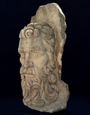 statue of a man with a beard and a goat ' s head on a black background