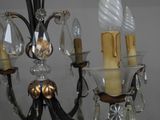 a chandelier that has three candles on each of it
