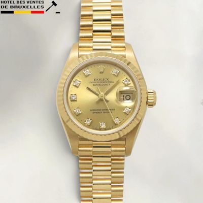 an image of a gold rolex watch with diamonds on the dial