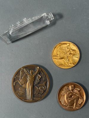 three gold coins and a silver coin sitting on a table