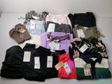 many different types of clothing on a white table
