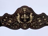 a wooden bench with a decorative design on it