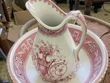 a pitcher and a plate on a table in a room