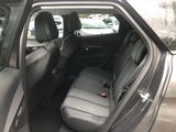 the back seat of a car with a bottle of beer in it