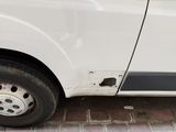 a white van with holes in the side of it ' s door