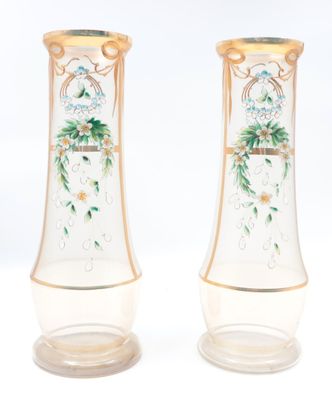 two vases with flowers painted on them on a white surface