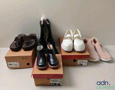several pairs of women ' s shoes sitting on top of boxes on a table