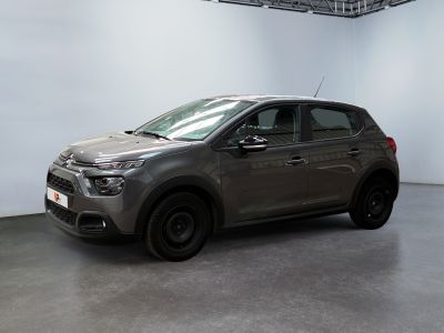 the grey car is parked in a large room with a white wall