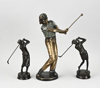 three bronze figurines of a man playing golf and a woman swinging a golf club
