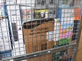 a large metal cage with boxes on top of it