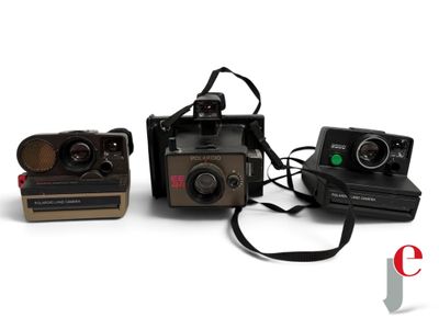 three polaroid cameras sitting next to each other on a white surface
