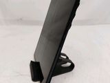 a black tablet computer on a stand on a white surface