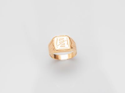 a close up of a gold ring with a square signet on it