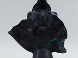 statue of a bird perched on top of a statue of a head