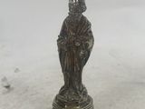 an antique bronze figurine of a man with a hat on his head