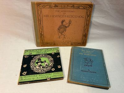 three books are sitting on a white surface with a white background