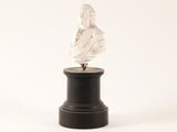 white marble bust of a woman on a black pedestal