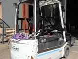 a fork lift truck parked in front of a building