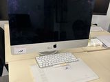 a computer on a desk with a keyboard and mouse