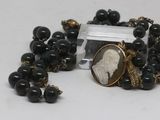 a necklace with a picture of a woman surrounded by beads