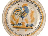 a plate with a rooster painted on it