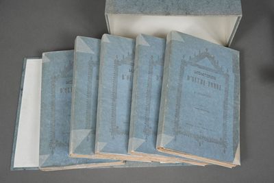 six blue books in a box with papers on top of them