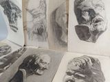 sketches of a man ' s head and a woman ' s face in a book