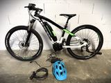 a bike that is sitting next to a blue helmet