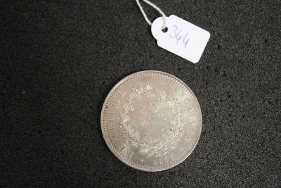 a small silver coin with a price tag on it