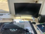 a computer desk with a keyboard, mouse, and monitor