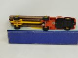 a toy train on a box with logs on it