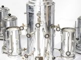 a group of silver teapots sitting on top of each other
